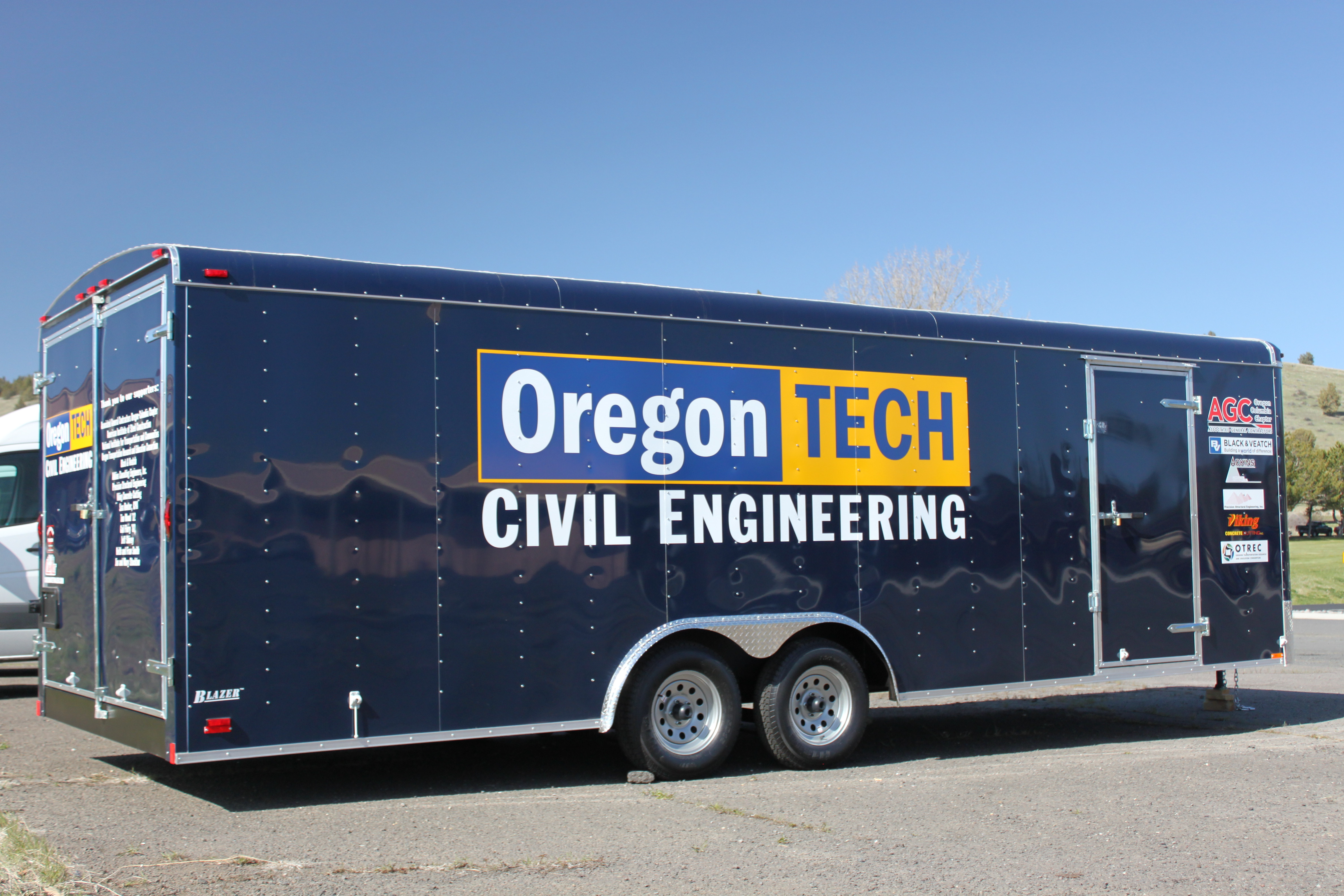The purchase of this trailer would not have been possible without the continued support of businesses such as Associated General Contractors Oregon-Columbia Chapter, American Institute of Steel Construction, National Institute for Transportation and Communities, Oregon Transportation Research and Education Consortium, Black & Veatch, Adkins Consulting Engineers Inc., Precision Structural Engineering, and Viking Concrete Cutting, along with donors Sara Reuter CPA, Tom Wood '12, Gail Flory '82, Jeff Shirey, Keith and Fran Smith, and Jim and Mary Stockton. Frontier Trailer in Klamath Falls continues to provide support of Oregon Tech and worked with the Civil Engineering department to allow for the purchase of this trailer. Signvertise of Klamath Falls also provided decals at a reduced cost. civil engineering trailer